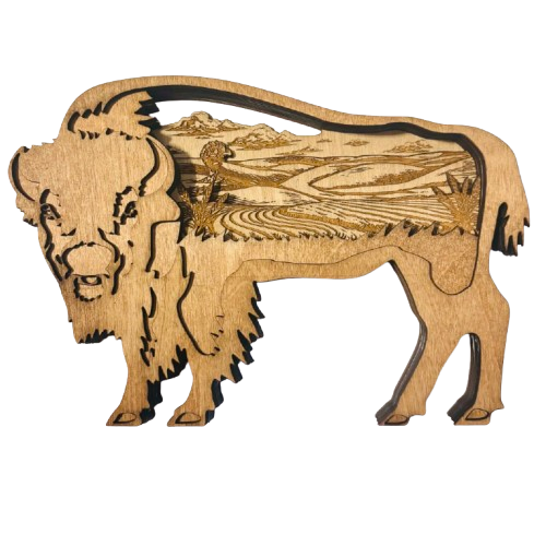 A laser-cut wooden plaque in the shape of a bison, with an engraved landscape scene visible through the side, shown on a plain white background.