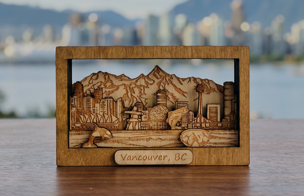 Wooden model of Vancouver, BC with cityscape and mountains in a box